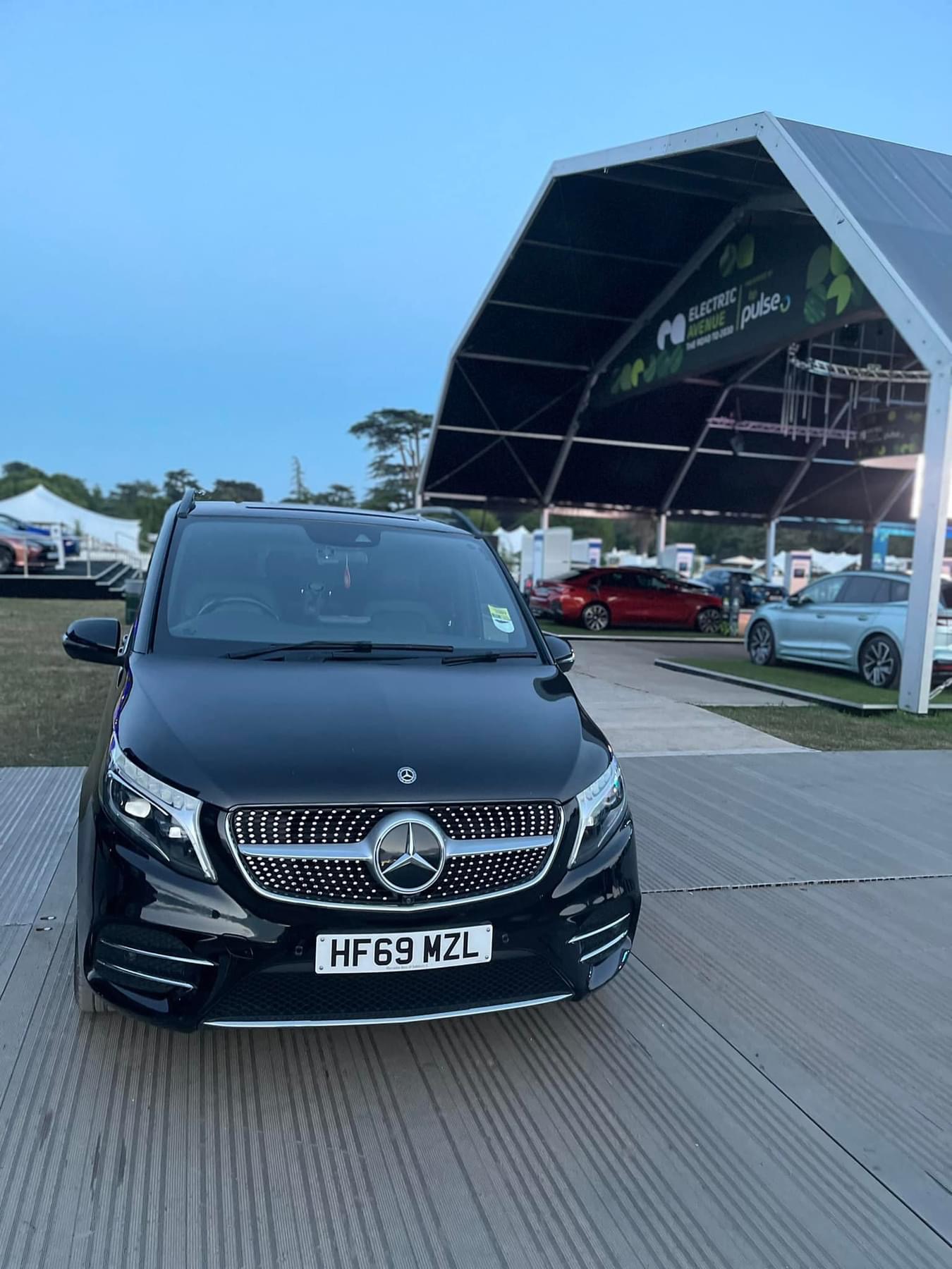 premium-estate-car-at-outdoor-concert-venue-under-blue-sky